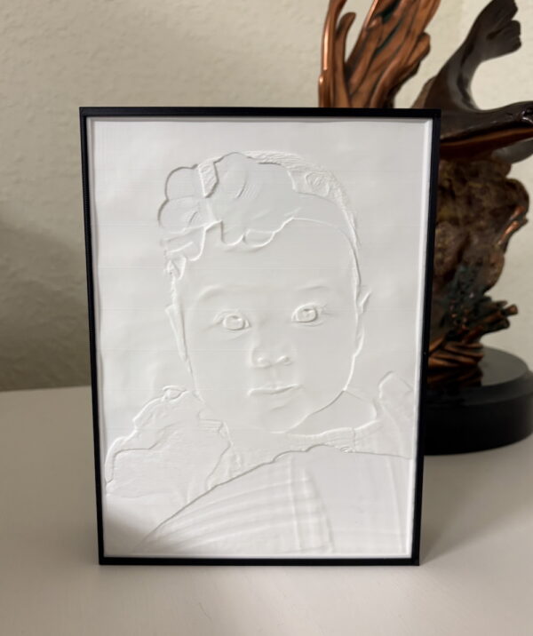 Lighted 3D printed lithophane picture box with image of a jeep going through mud. Framed in black.