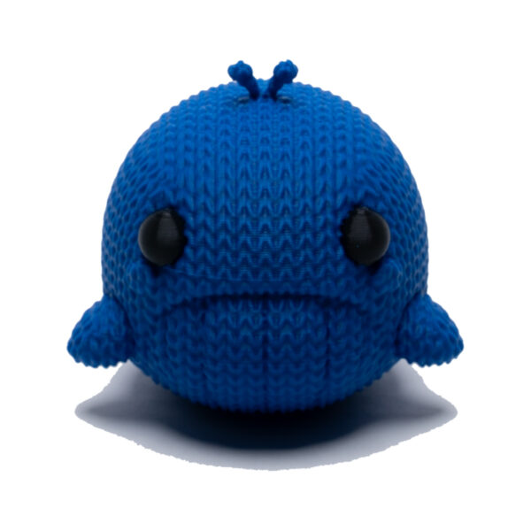 Sad blue knitted whale toy facing forward. He floats!