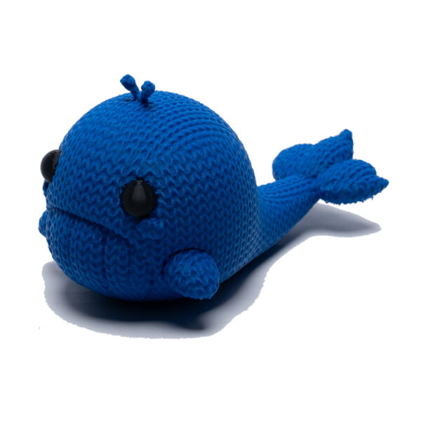 Sad blue knitted whale toy facing forwards the side. He floats!